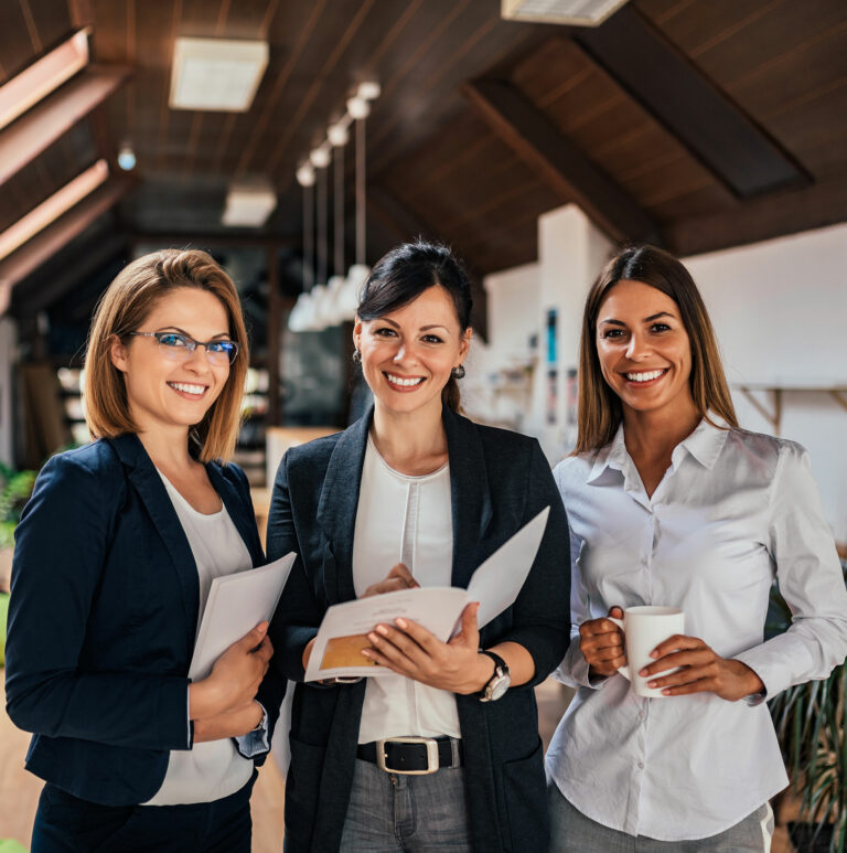 Three professionals standing together, representing teamwork, innovation, and quality excellence at Axchem.