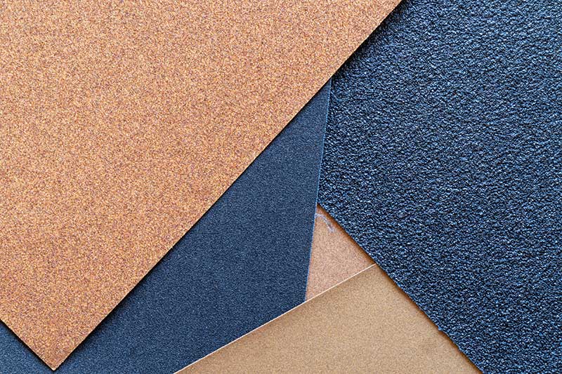 Close-up of specialty paper material samples showing contrasting surfaces and textures.